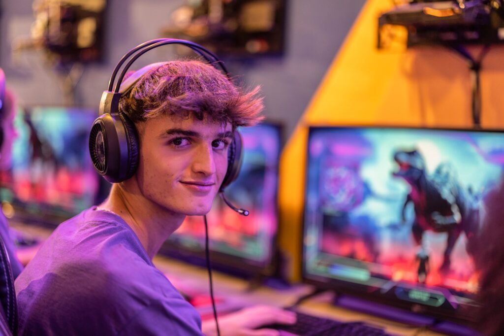 caucasian man gamer looking at camera while playing video games with compute gaming club